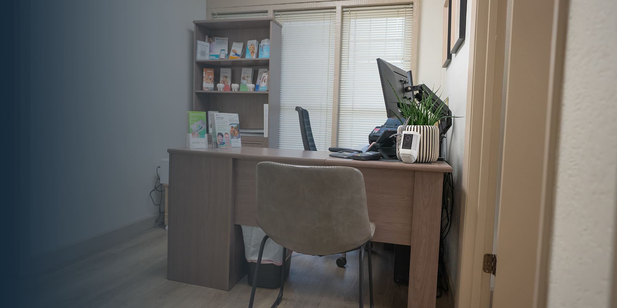 Dental office consultation space with desk and seating