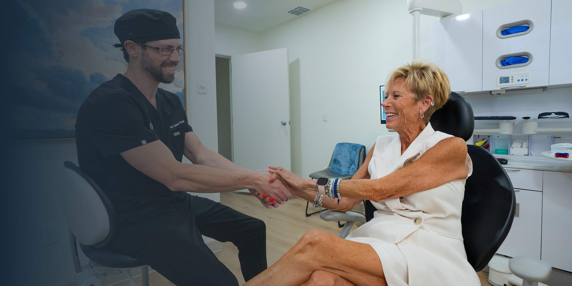 Dr. Thompson and patient holding hands