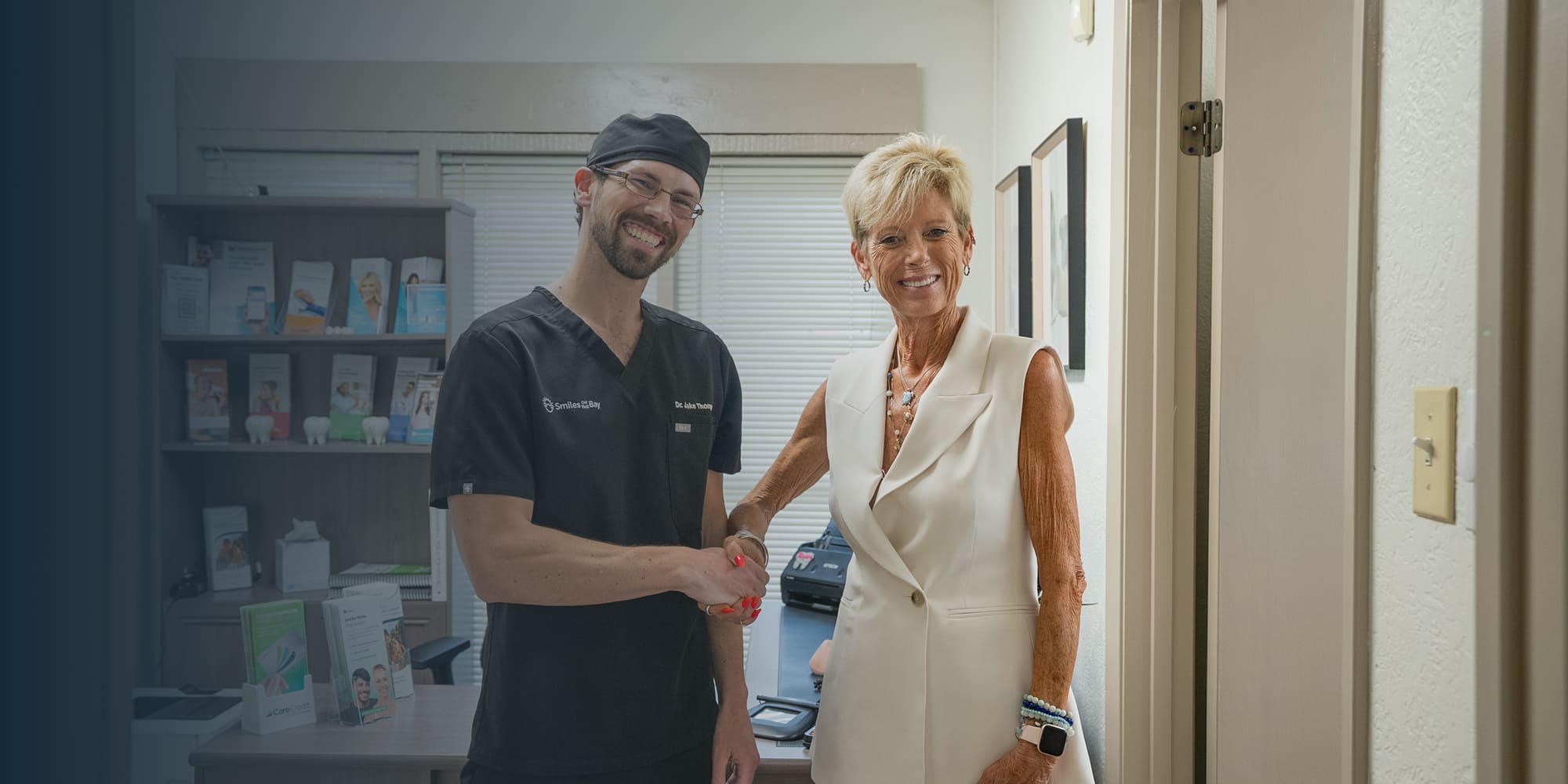 Dr. Thompson and patient shaking hands and smiling