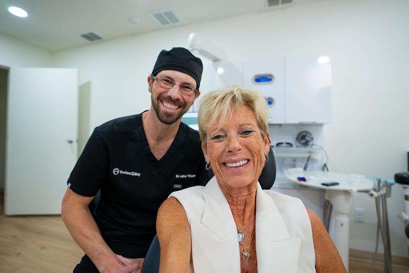 Dr. Thompson and patient smiling at camera