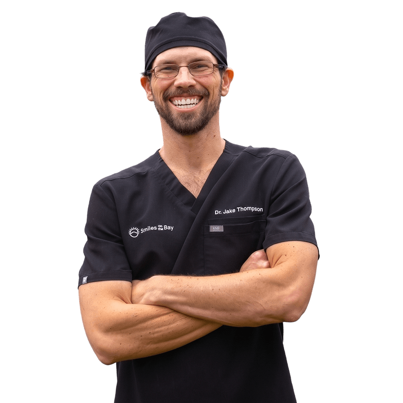 Dr. Thompson smiling with arms folded