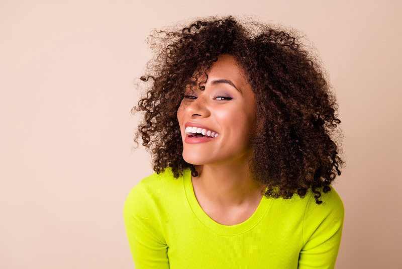 frizzy hait woman with big smile