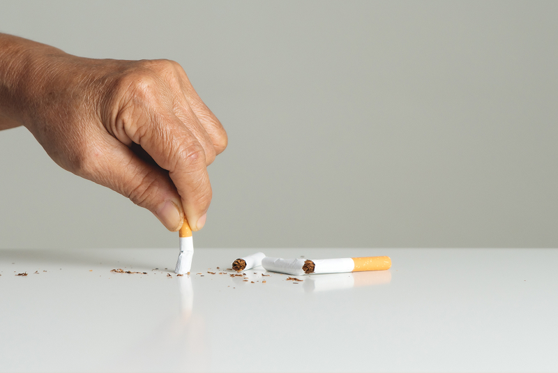 hand putting out cigarette