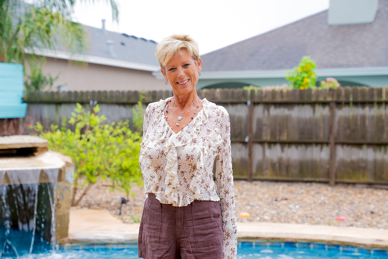 patient in backyard showing off smile