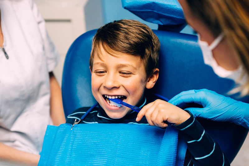 young boy brushing teeth