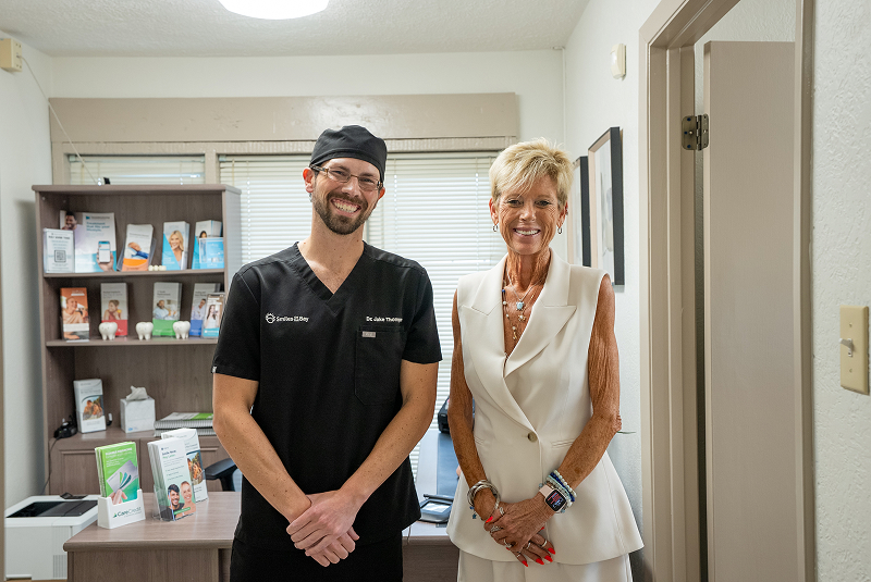 Dr Thompson standing with patient in back office